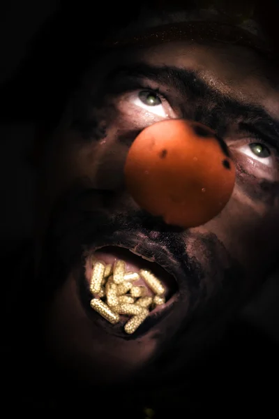 Clown With Capsules In Mouth