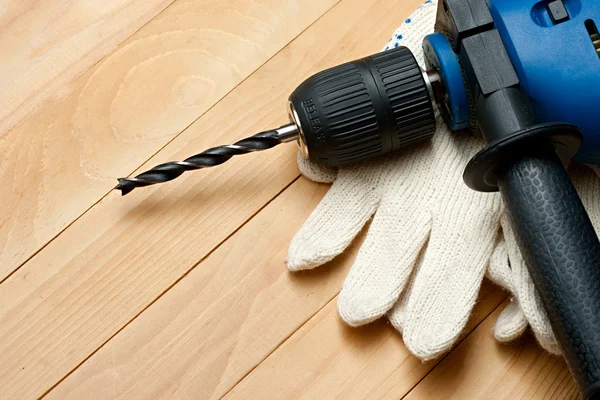 Hand drill and protective gloves