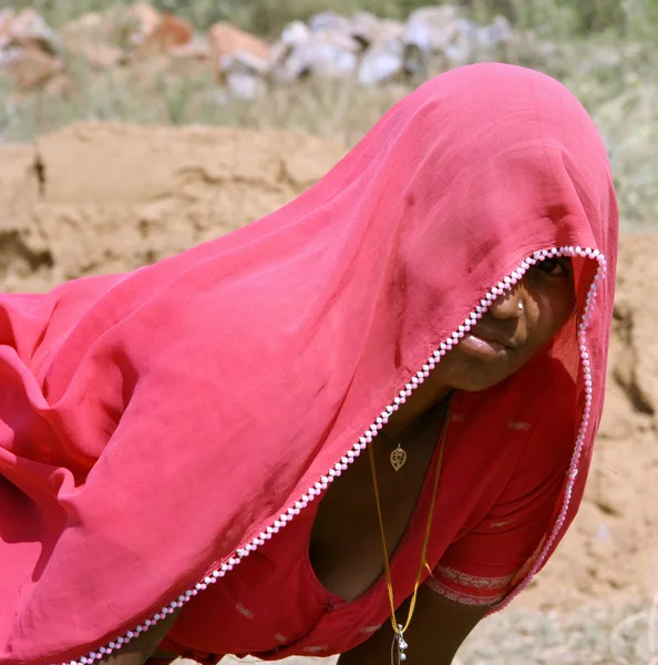 Village woman taking break from work, rajasthan, india