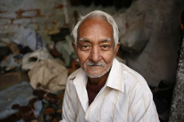 Portrait of old indian shoemaker in delhi, india