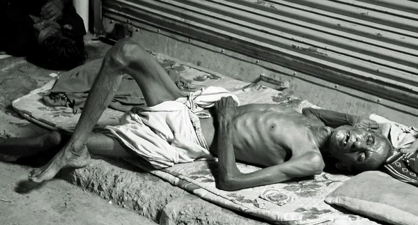 Old man sleeping on footpath, delhi, india