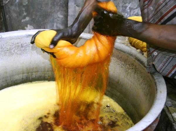 Man wringing cloth during dyeing, delhi, india