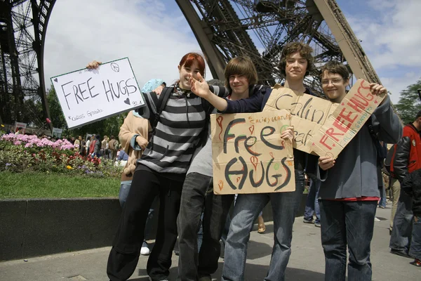 Kids giving free hugs at the eiffel tower in paris, france