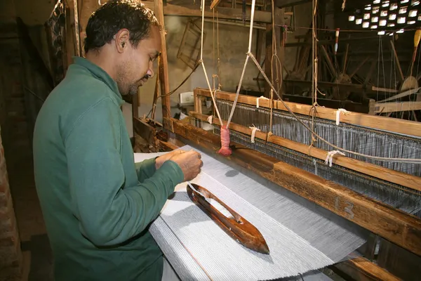 Weaver working handloom at workshop, delhi, india