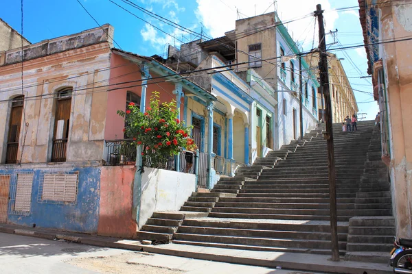 Long Padre Pico street staps with crumbling buildings in Santiago de Cuba