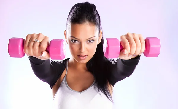 Young woman hang up hands weights