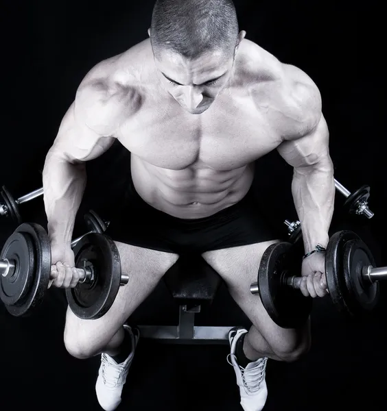 Man on bench with a bar weights in hands training
