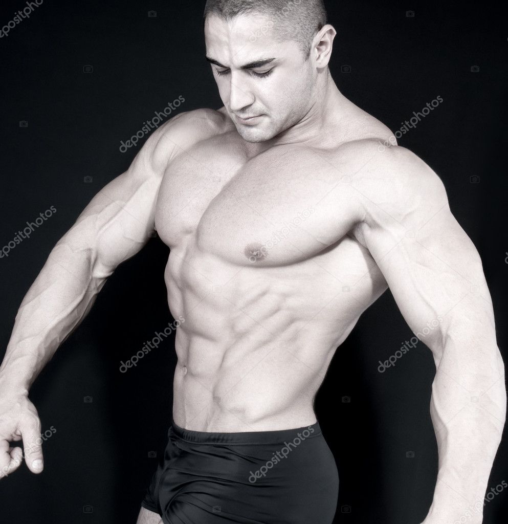 Athletic sexy attractive male body builder, demonstrating contest