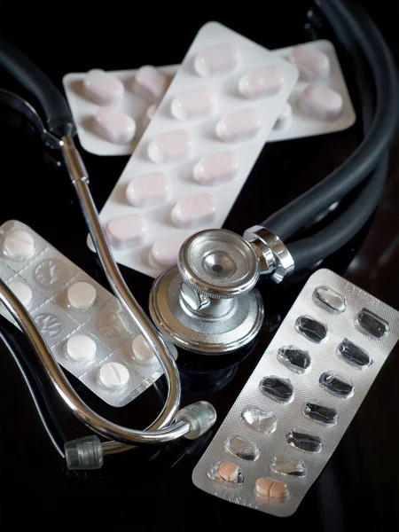 Stethoscope and blister pills close-up