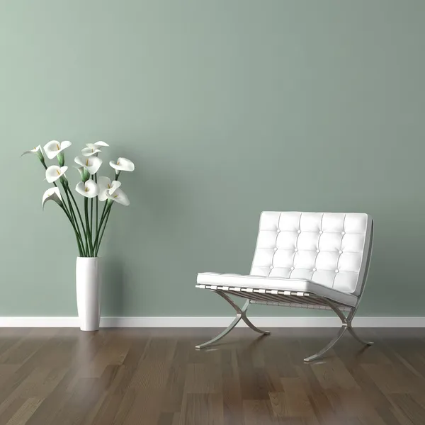 White barcelona chair on green