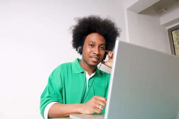 African American listen to music with laptop