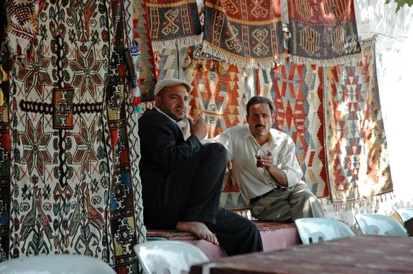 Turkish carpet vendors selling carpets in Cappadocia, Turkey