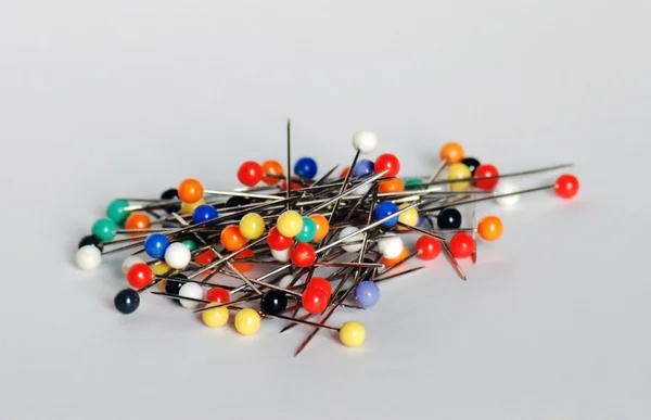 Many colorful sewing pins isolated