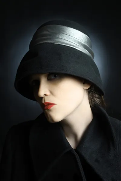 Fashion portrait of beautiful woman in black hat