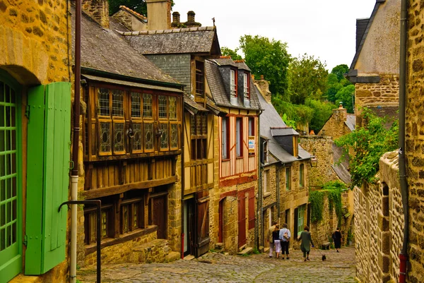 Paved medieval street with Breton architectural style houses in Dinan, Brit