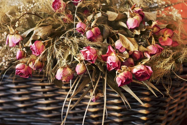 Arrangement of dried roses in a basket