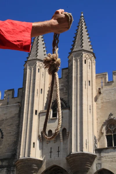 Executioner with a noose in front of the Palace of the Popes