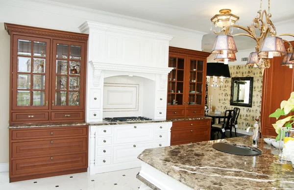Large kitchen with a marble table in the center