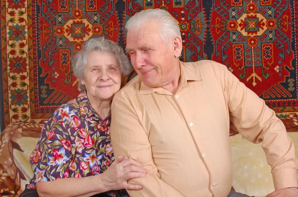 Seventy year old couple smiling at home