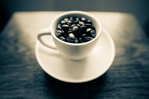 Black and white coffee mug on white plate