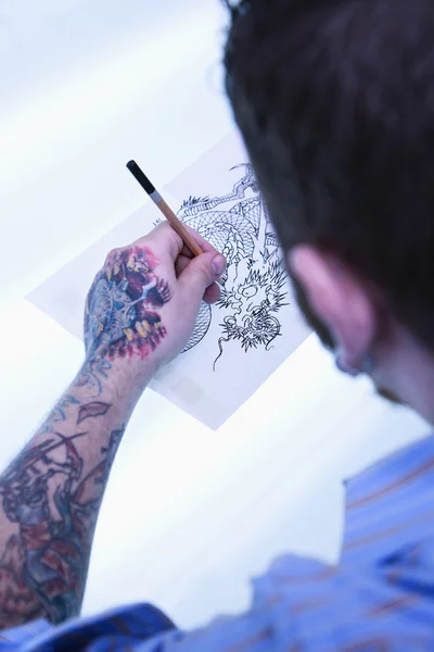 Tattoo artist drawing.