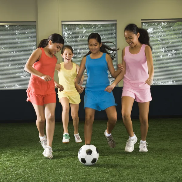 Girls playing soccer.