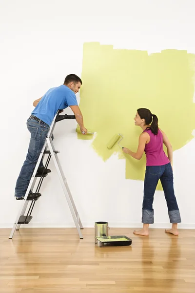 Couple painting house.