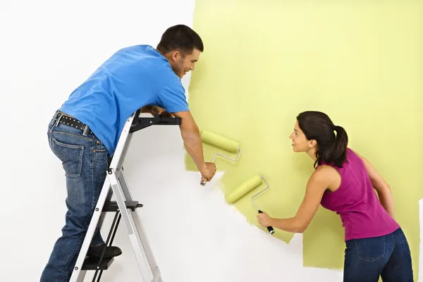 Couple painting home.