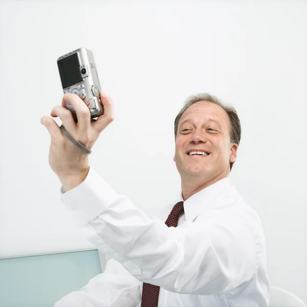 Businessman taking photo of self