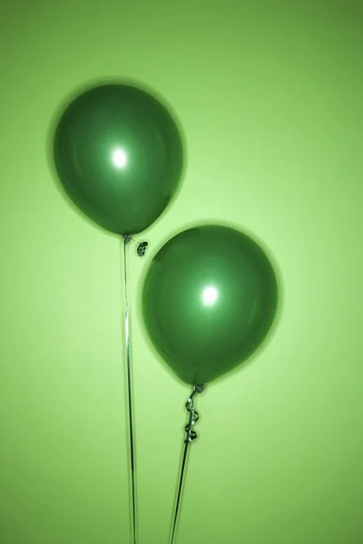 Two green balloons.