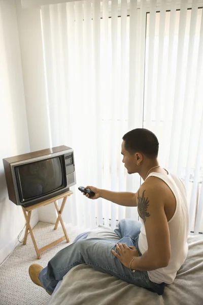 Young Man Turning on TV