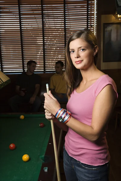 Woman by pool table.