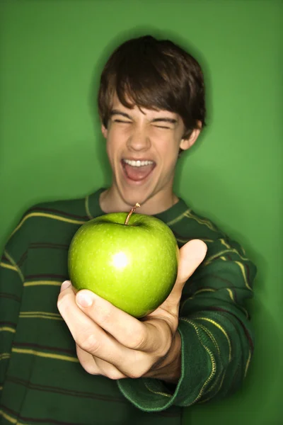 Boy holding apple.