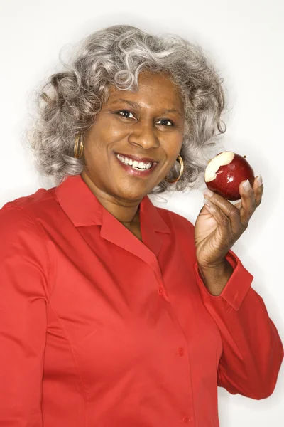Woman eating apple.