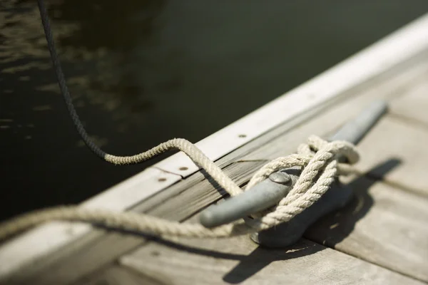 Rope tied to boat dock.