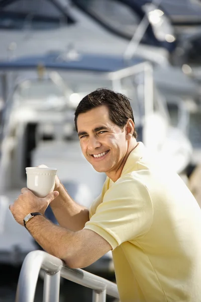 Man holding coffee cup.
