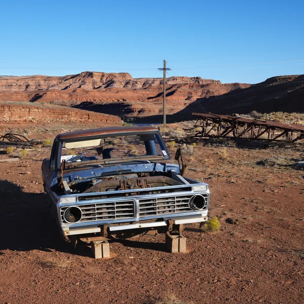 Junk car in desert.