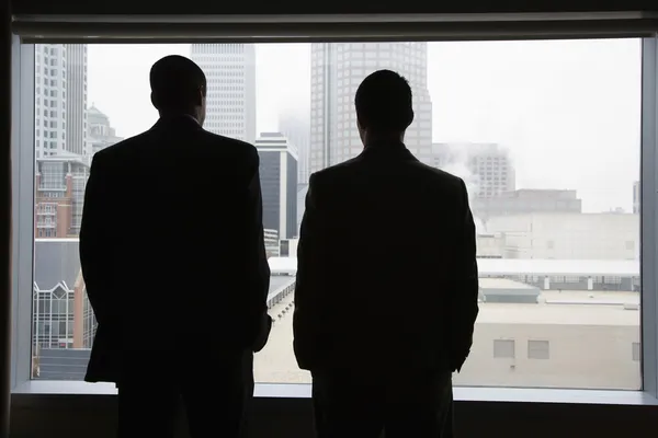Businesspeople Looking Out of a Window