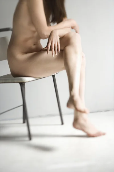 Sitting nude woman.