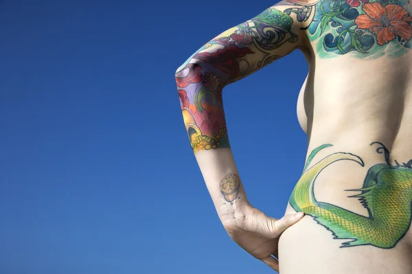 Sexy nude tattooed woman.