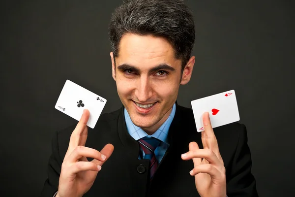 Young lucky gambler with cards