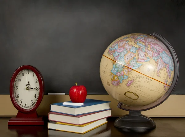 Blank Chalkboard with globe, books and clock