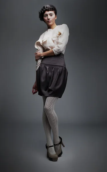 Lovely fashion model brunette girl in retro black skirt, white shirt