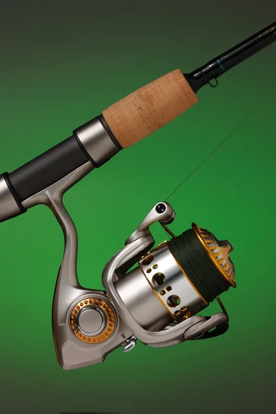 Spinning reel attached to a cork handled fishing pole