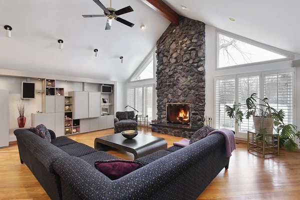 Family room with two story stone fireplace