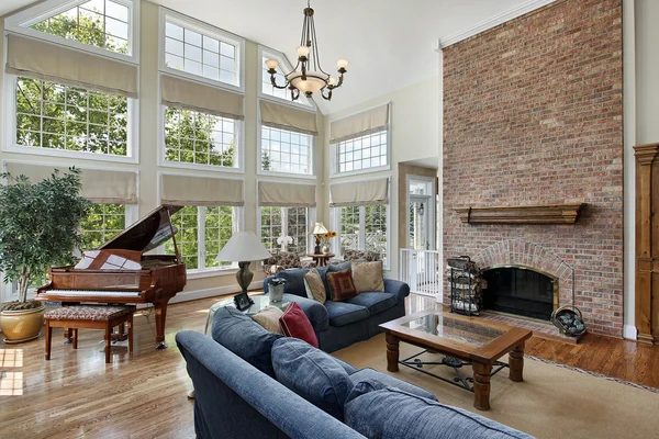 Large family room with two story windows