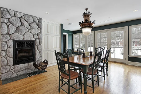 Breakfast room with stone fireplace