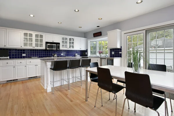 Kitchen with blue tile backsplash