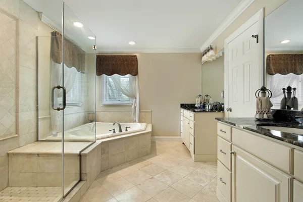 Master bath with cream colored cabinetry