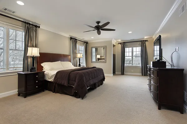 Master bedroom with dark wood furniture